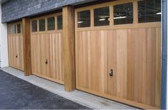 two wooden garage doors in front of a building