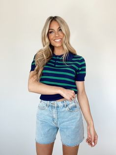 Introducing the Paige Striped Polo Top - the perfect blend of preppy and chic. With its collared neckline, button closures, and nautical stripes, this top has an elevated and coastal feel. Made with ultra soft, stretchy fabric, it's the ideal choice for your spring vacation or a trendy brunch date, dinner, or drinks. Cropped and fitted for a stylish look. Self 80% Viscose 20% Nylon Hand wash cold. Preppy Top With Striped Polo Collar, Preppy Polo Collar Top With Striped Details, Preppy Tops With Striped Polo Collar, Navy Tops With Striped Collar, Navy Top With Striped Collared Neckline, Navy Tops With Striped Collared Neckline, Navy Fitted Top With Striped Collar, Fitted Navy Top With Striped Collar, Preppy Striped Polo Collar Top