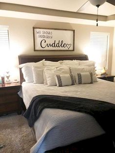 a bedroom with a bed, nightstands and two lamps on either side of the bed