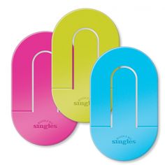 three different colored paper clips on a white background