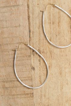 The Large Anjou Hoops exude elegance, made from sterling silver, in a natural shaped hoop with a gold clasp. The organic and irregular shape of the hoop highlights natural beauty, with a minimalist but bold effect. Minimalist Teardrop Hoop Earrings With Polished Finish, Modern Hammered Drop Jewelry, Minimalist Hammered Teardrop Jewelry, Modern Hammered Teardrop Jewelry, Hand-forged Teardrop Hoop Earrings, Silver Teardrop Hand-forged Hoop Earrings, Everyday Hand Forged Teardrop Hoop Earrings, Silver Teardrop Hand Forged Hoop Earrings, Hand Forged Teardrop Silver Hoop Earrings