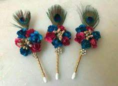 three different colored flowers and peacock feathers on top of each other with the words tiak stick