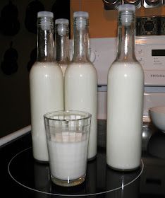 three bottles and a glass sitting on top of a counter