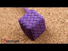 a purple knoted bag sitting on top of a counter