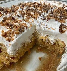 a cake with white frosting and nuts on top