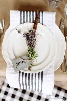 a place setting with white plates and silverware