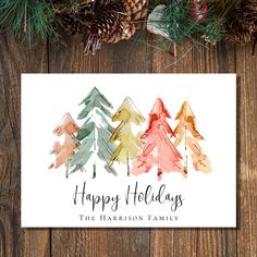 a holiday card with watercolor trees and pine cones