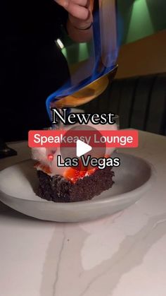 a person cutting into a piece of cake on a white plate with the words news speakee lounge las vegas