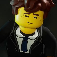 a lego man wearing a suit and tie with his hair blowing back in the wind