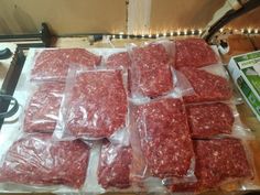 several packages of ground meat are wrapped in plastic and ready to be packaged into the oven