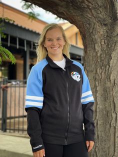 Head to the game in style with this Sporting Kansas City Black MVP 2.0 Track Jacket! Show off your Sporting KC pride in this Athletic Jacket, which features a embroidered felt logo at left chest. Go Sporting! Contrast color self fabric sleeve stripes, Zip Front closure, Welt pockets, Embroidered felt logo at left chest, Mitchell & Ness script embroidery on right cuff, Fit: Runs Small, 66% COTTON / 34% POLYESTER, Machine washable, 4 Sporty Long Sleeve Outerwear For Team Events, Sporty Long-sleeve Outerwear For Team Events, Sporty Winter Outerwear For Team Events, Sporty Fitted Track Jacket For College, Fitted Sporty Track Jacket For College, Urban Fitted Track Jacket For Sports, Script Embroidery, Sporting Kc, Embroidered Felt