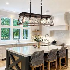 a large kitchen island with four chairs around it