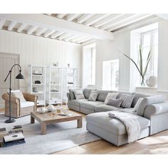 a living room filled with furniture and white walls