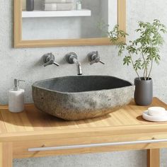 a bathroom sink sitting on top of a wooden counter