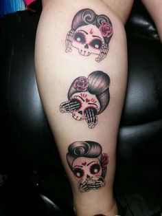 a woman's leg with three skulls on it