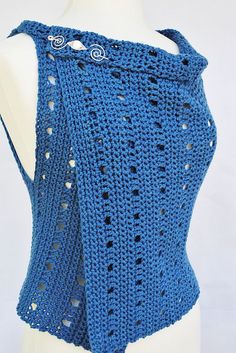 a blue crocheted top with holes on the back and shoulder, made from yarn