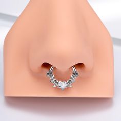 This heart and rose septum ring has two roses engraved alongside the hoop and a heart CZ at the center, constructing a delicate and dainty outlook. It enlightens the divine feminine quality hidden inside each woman. A perfect choice for loved ones or yourself. Diamond Accented Septum Ring Gift, Pink Septum Ring, Heart Septum Ring, Rose Gold Septum Ring, Heart Nose Ring Bodydazz.com Body Jewelry, Titanium Belly Button Rings, Ring Day, Conch Hoop, Two Roses