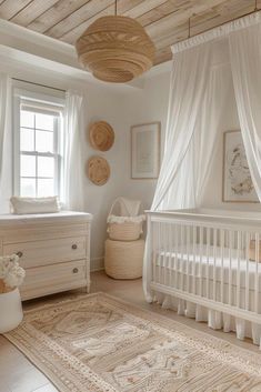 a baby's room with a crib, dresser and bed in white colors