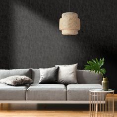 a living room with black walls and grey couches