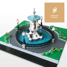 a lego model of a fountain in the middle of a park