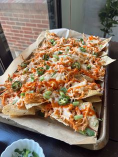 a tray filled with nachos sitting on top of a table