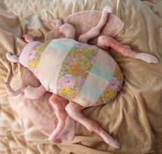 two stuffed animals laying on top of a bed