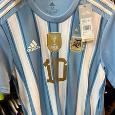 a soccer jersey with the number 10 on it is hanging up in a store window