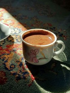 a cup of hot chocolate sitting on top of a table