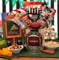 a football themed gift basket with snacks, crackers, and candy on a table