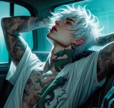 a woman with white hair and tattoos sitting in a car next to a dragon tattoo on her arm