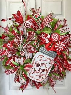 a christmas wreath with candy canes on the front door