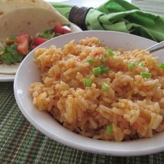 there is a plate of rice and a burrito on the table