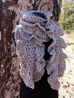 a crocheted scarf hanging from a tree