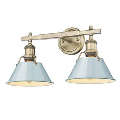 two light bathroom fixture in an antique brass finish with blue shade shades on the wall