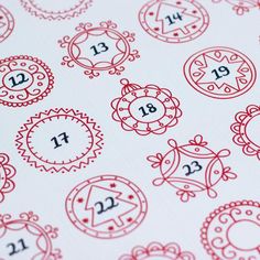 a close up of a red and white pattern with numbers on it's surface