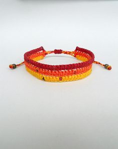 Ombre bracelet, Triple Macrame bracelet, Yellow Red Orange, Earthy, Beaded bracelet, Knotted, Girlfriend gift, Festival jewelry, Micromacrame, Hippie This handknotted bracelet is made using yellow,orange and red waxed string. It is adorned with seed beads. It is adjustable to fit a lot of sizes. Custom orders for different colour combinations are welcome Similar evil eye bracelets from my shop: https://www.etsy.com/shop/LuckyRatJewellery?section_id=14785936&ref=shopsection_leftnav_5 *Colours Multicolor Macrame Bracelets As Gift, Multicolor Macrame Bracelets Gift, Yellow Macrame Bracelet As Gift, Adjustable Orange Macrame Jewelry, Red Macrame Beaded Bracelets For Friendship, Adjustable Red Macrame Bracelets, Red Adjustable Macrame Bracelets, Red Macrame Braided Bracelets For Friendship, Red Macrame Bracelet Jewelry