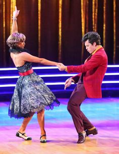 a man and woman dancing on the dance floor