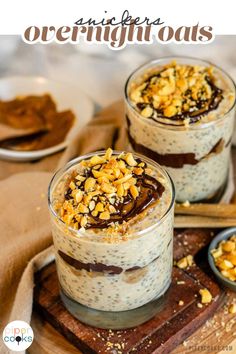 two glasses filled with overnight oatmeal sitting on top of a cutting board