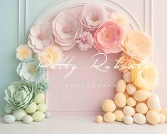 some flowers and eggs in front of a pink wall with the words patty roberts photography