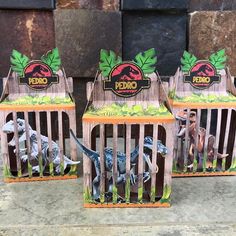 three wooden bird cages with dinosaurs in them