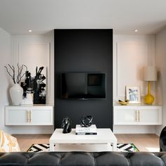 a living room filled with black and white furniture