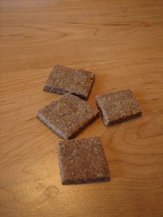 four crackers sitting on top of a wooden table