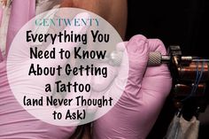 a woman wearing pink gloves holding a tattoo machine with the words, everything you need to know about getting a tattoo and never thought to ask