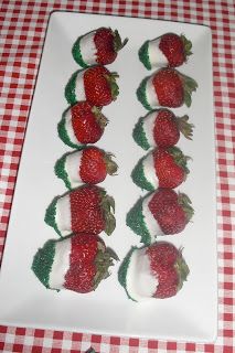 strawberries are arranged in the shape of hearts on a white plate with red and green checkered tablecloth