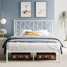 a bedroom with blue walls and white bedding has two drawers under the headboard