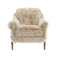 the chair is made out of sheepskin and has wooden legs, with a white background