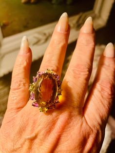 This is an authentic beautiful citrine peridot and amethyst ring. Size 9. The beautiful center stone is 35 ct citrine. It is surrounded by smaller peridot and amethyst. These beautiful gemstones are fashioned in a lovely sterling silver setting. This is a large statement ring. It is heirloom quality. Beautiful Gemstones, Ring Color, Amethyst Ring, Womens Jewelry Rings, Gemstone Ring, Statement Ring, Sterling Silber, Citrine, Halloween Shopping