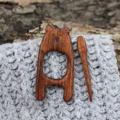 a small wooden object sitting on top of a blanket