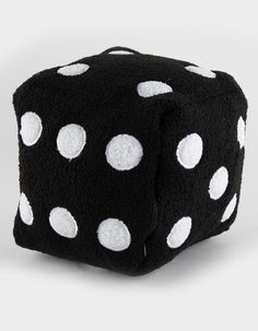 a black dice with white polka dots on it