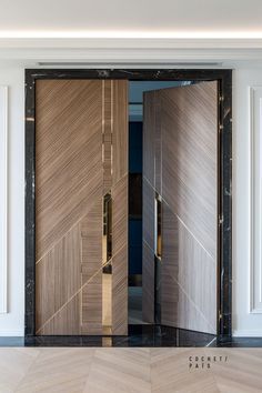 two wooden doors with black and gold trim